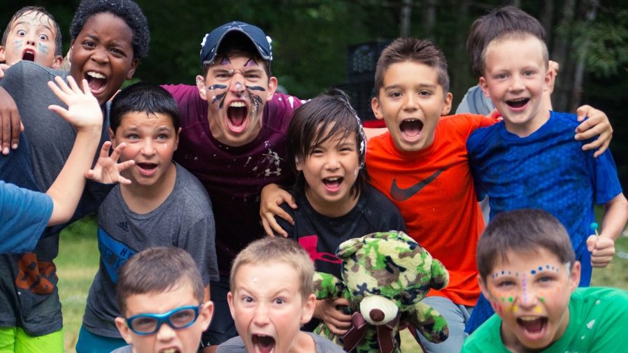 Young male campers with facepaint screaming