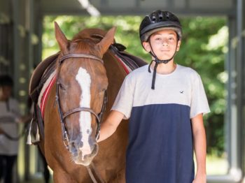 Brookwoods camper holding a horse