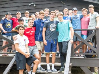 Boys standing on a cabin porch