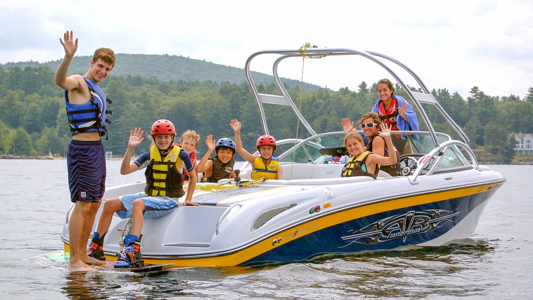 Campers and staff on a motorboat