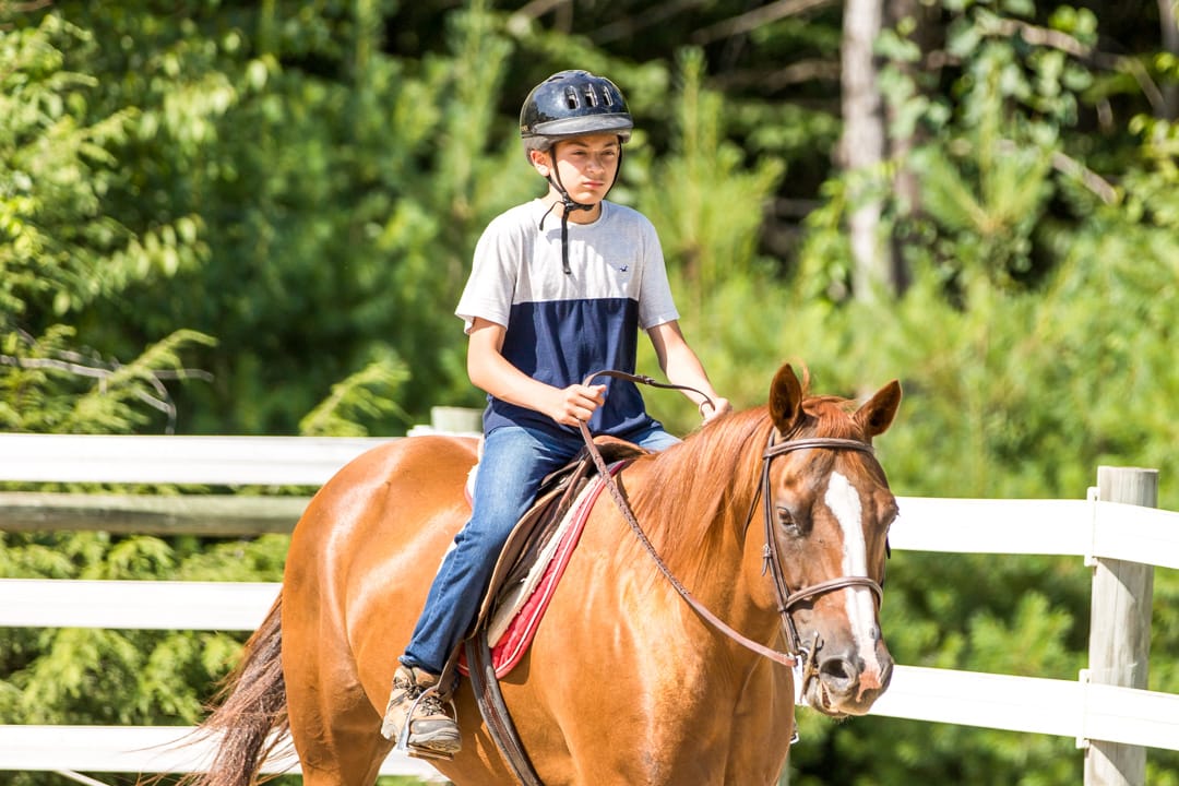 Camper riding a horse