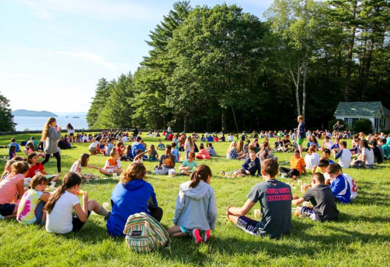 Campers sitting on the front lawn