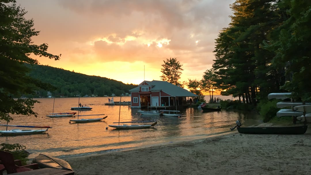 Waterfront at sunset with canoes