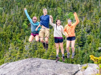 Teens jumping on a mountain on the Leadership Development Programs