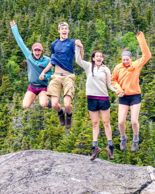 Teens jumping on a mountain on the Leadership Development Programs