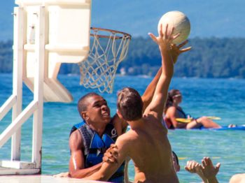 Two boys playing water basketball at Brookwoods