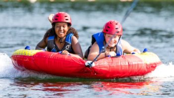 Two girls water tubing