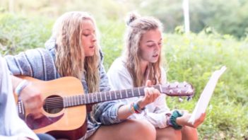 Staff singing and playing guitar