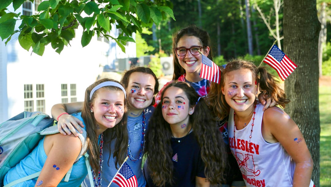 Staff and campers with flags for the 4th of July