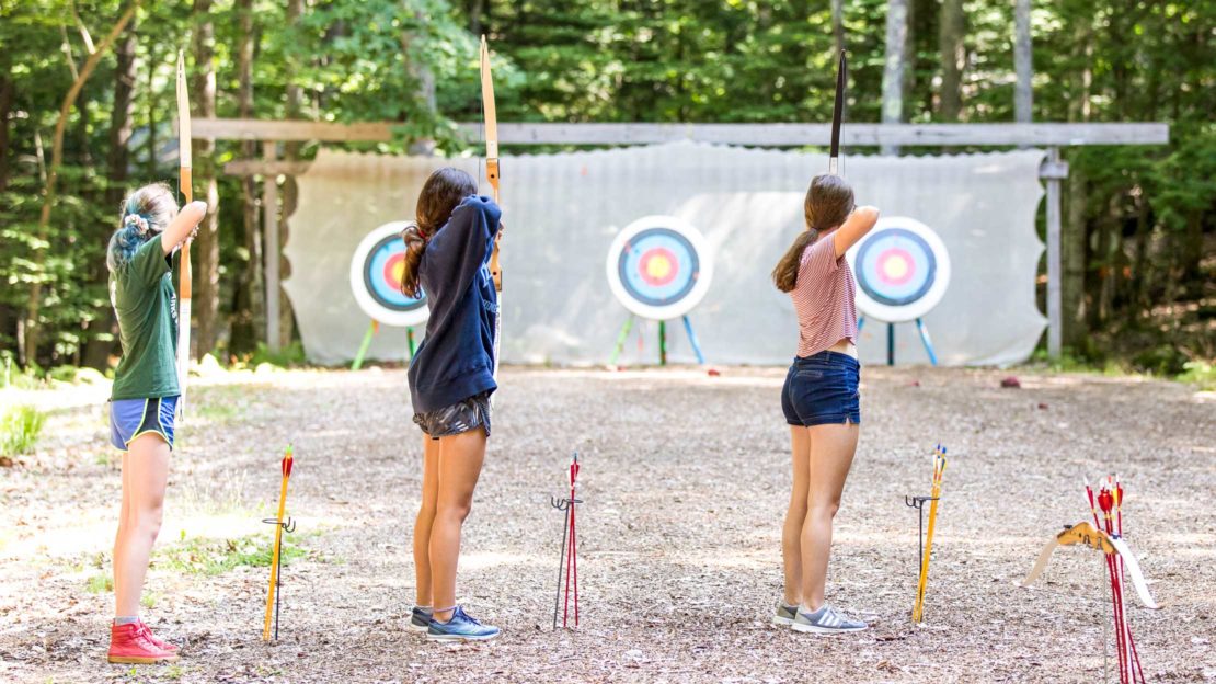 Campers aiming at archery targets