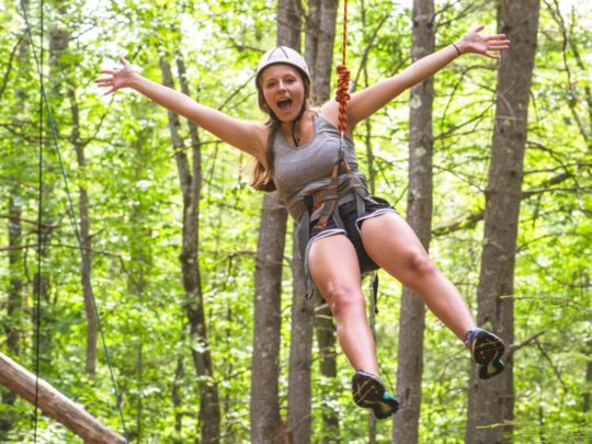 Camper on the ropes course during basic camp