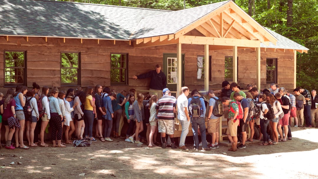 Campers lining up outside of cabin for prayer