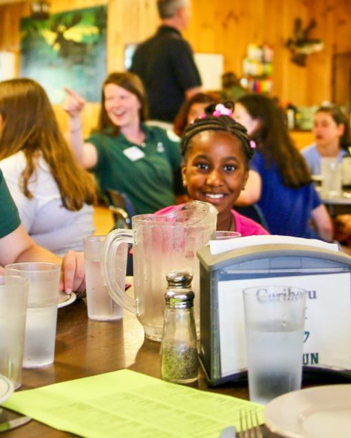 Campers and staff eating a meal in the dining hall