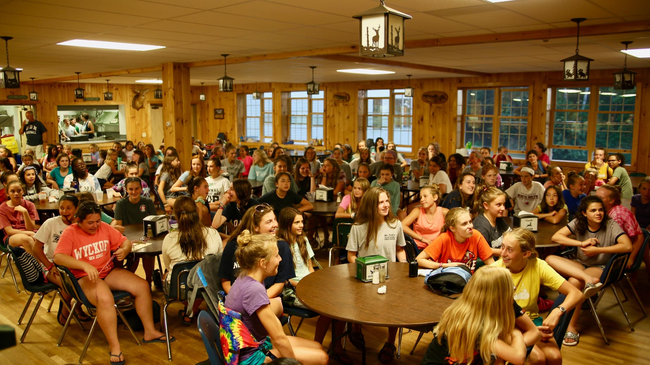 Campers and staff eating a meal in the dining hall