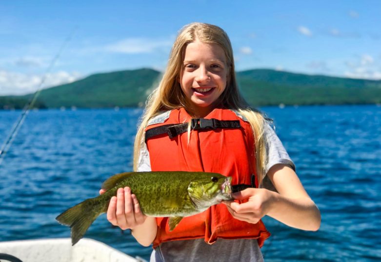 Girl with large fish she caught