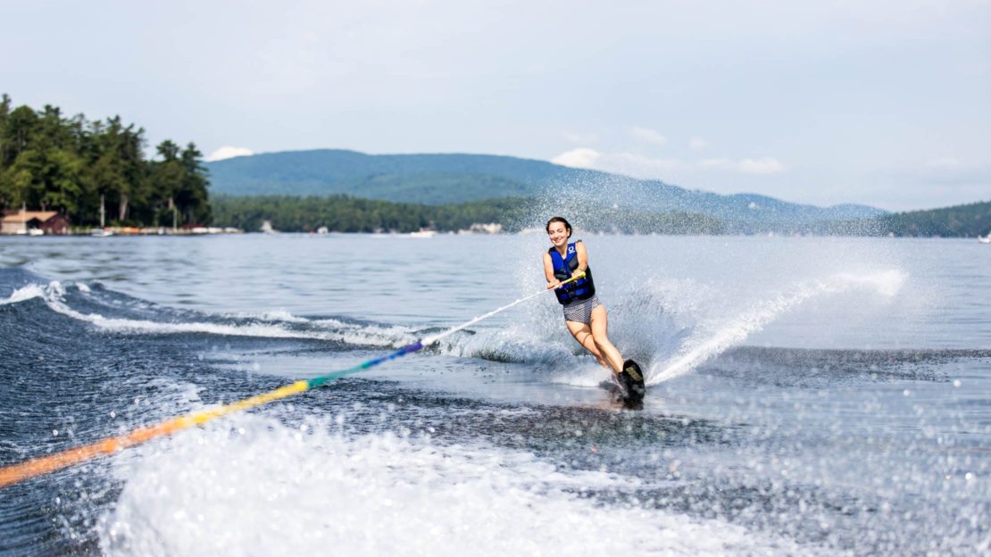 Girl wakeboarding on lake at Deer Run