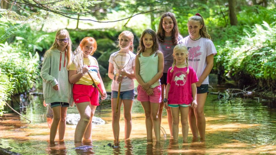 Girls standing in a stream