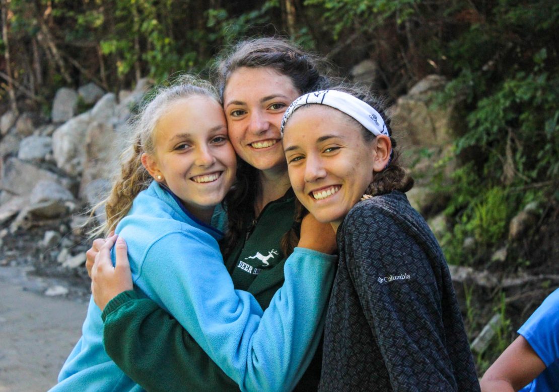 Three girls hugging on the Leadership Development Program