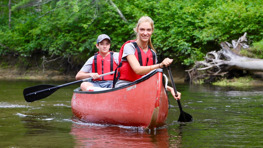 Two campers canoeing on the Saco river