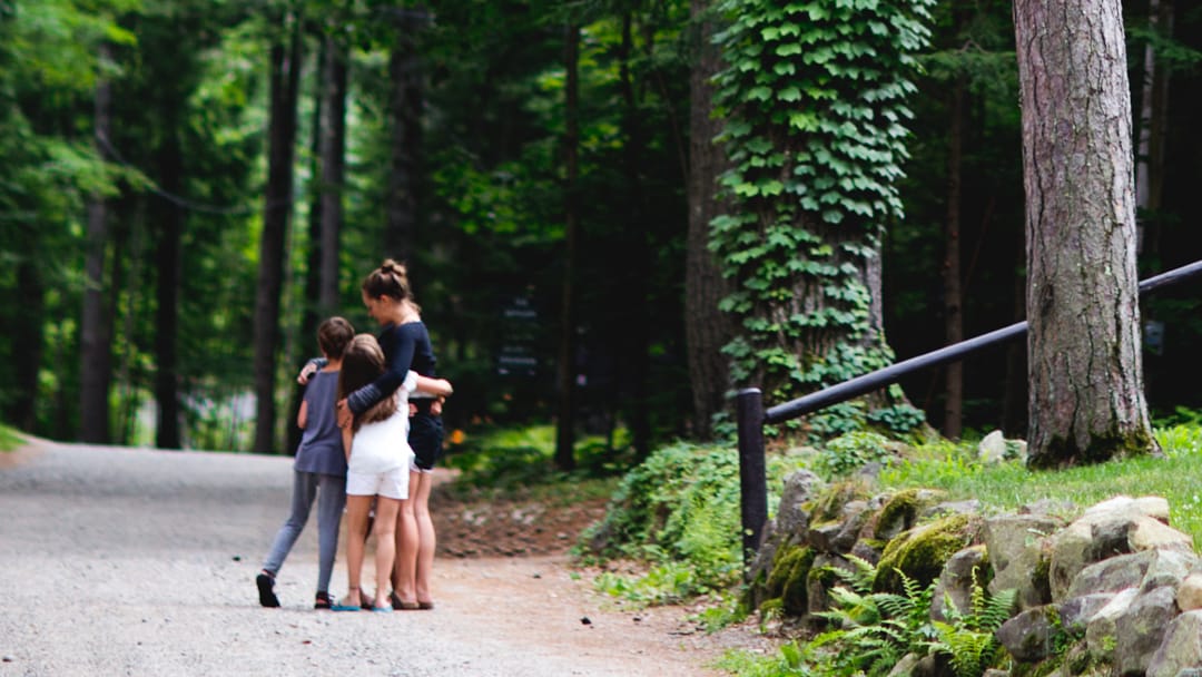 Campers hugging staff outside