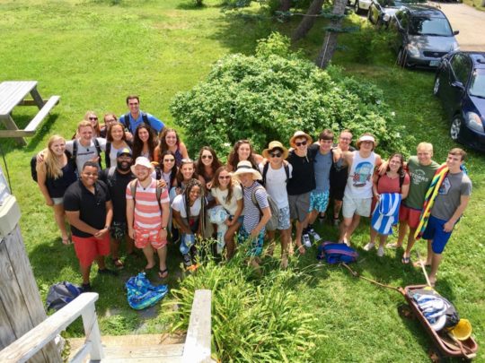 Large group of campers and staff standing on lawn