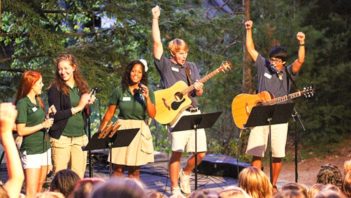 Staff singing and playing guitar