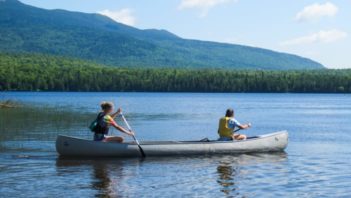 Two campers canoeing on a lake