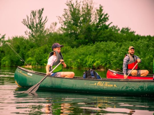 Staff and camper canoeing on a lake