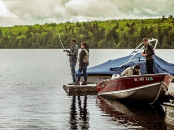 Staff fishing by a motorboat