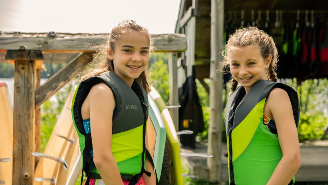 Two girls wearing life jackets