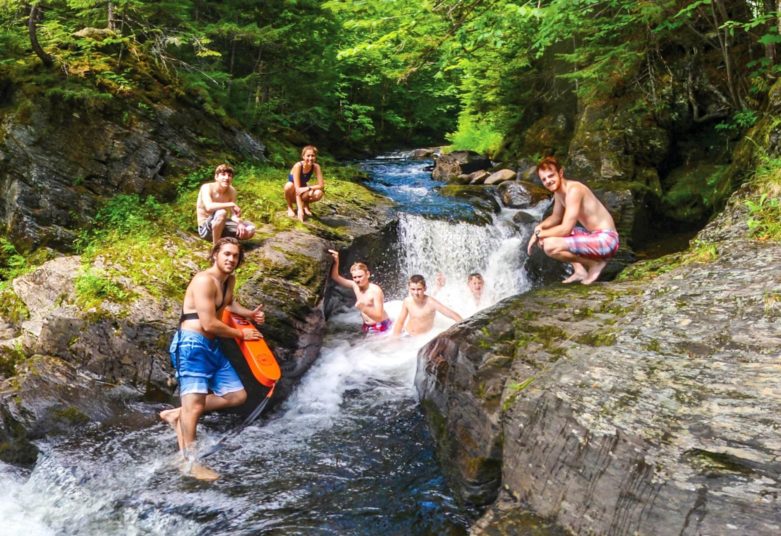 Group at a waterfall area at Moose River Outpost