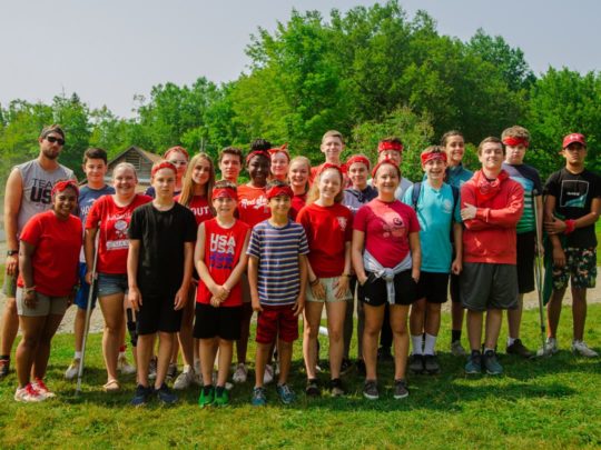 Staff and camper wearing red for a special event