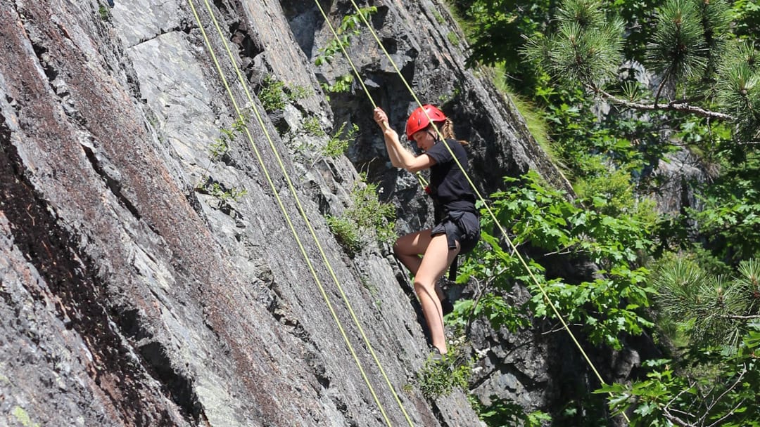 Girl rock climbing at WILD program