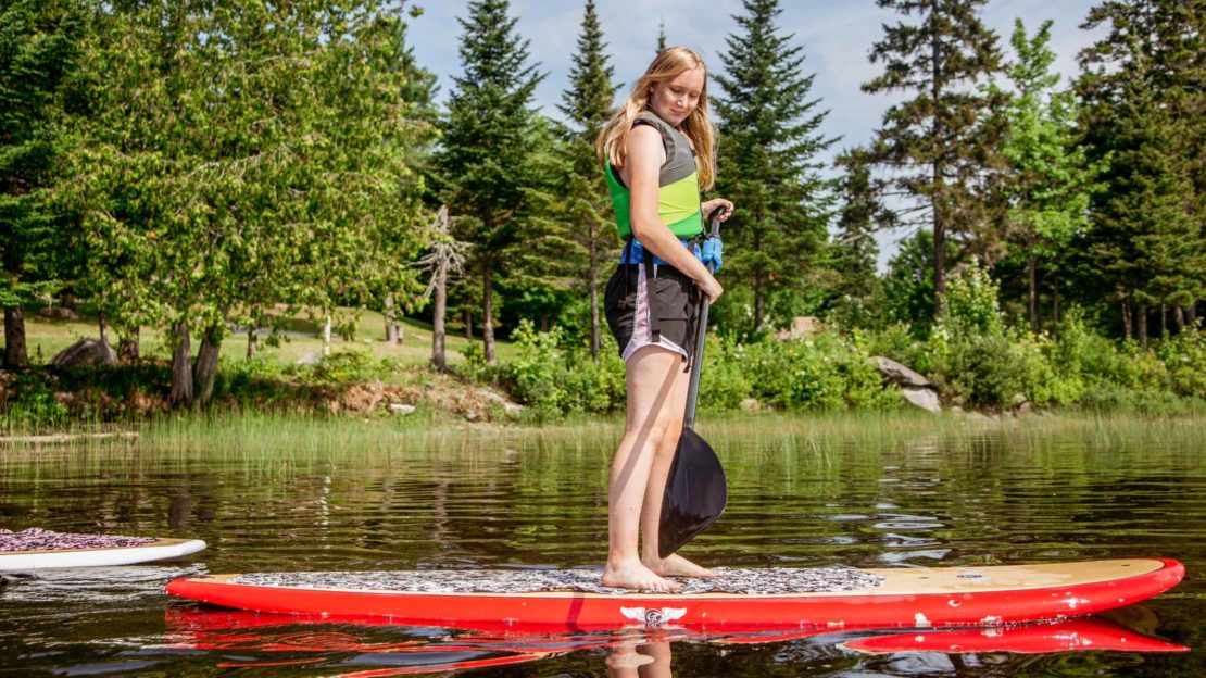 Girl on SUP board on the lake