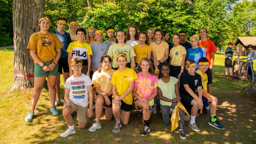 Staff and camper wearing yellow for a special event