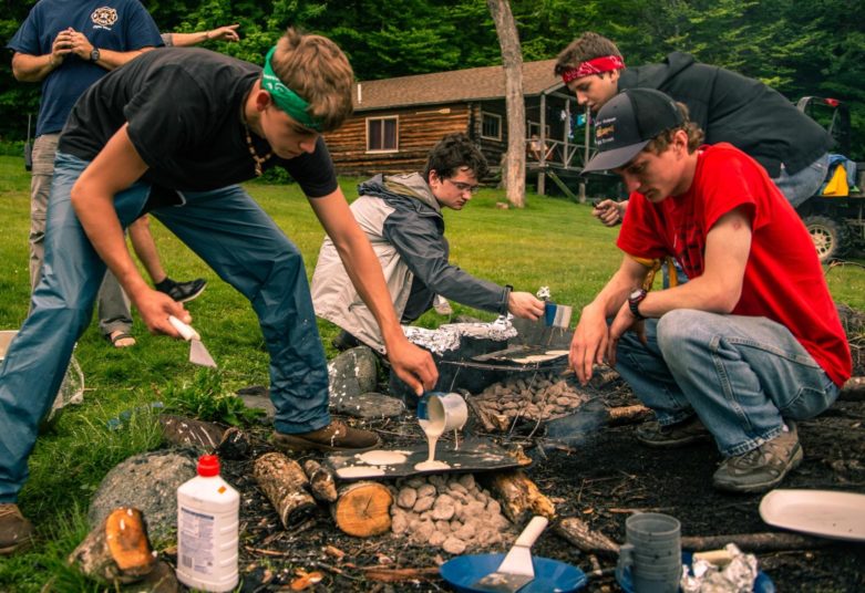 Campers building a campfire at Moose River Outpost