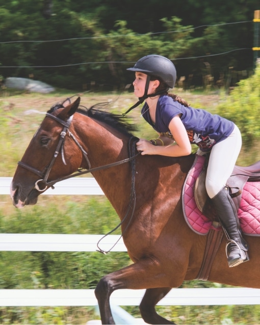 Camper riding a horse at Deer Run