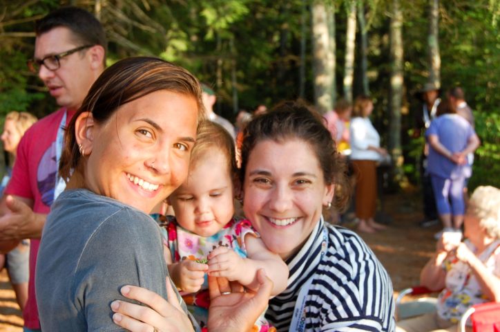 two female alumni with a baby