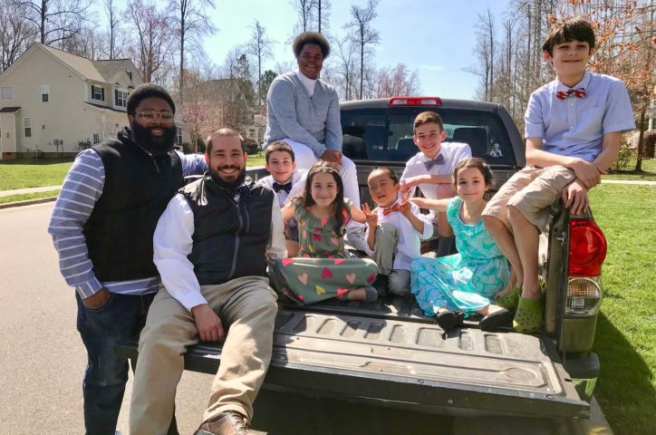 Alumni and family on pickup truck