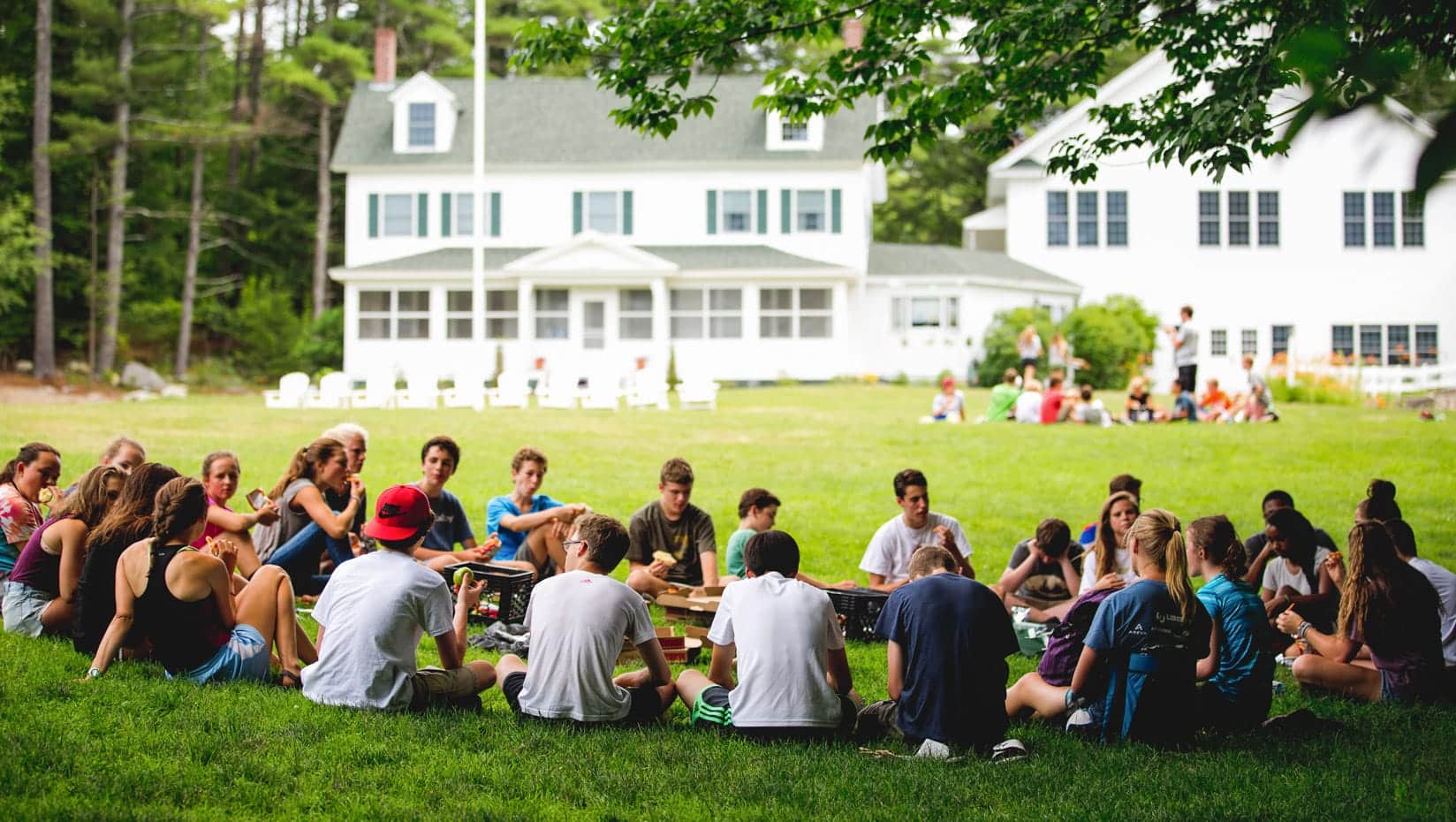 Brookwoods boys sitting in a circle in the grass