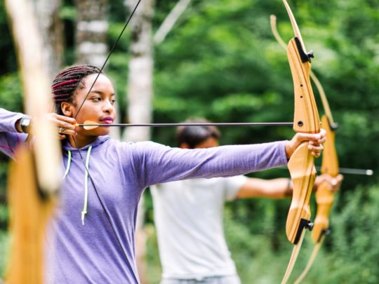 Girl shooting archery arrow