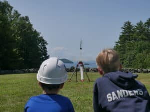 Two boys launching a rocket