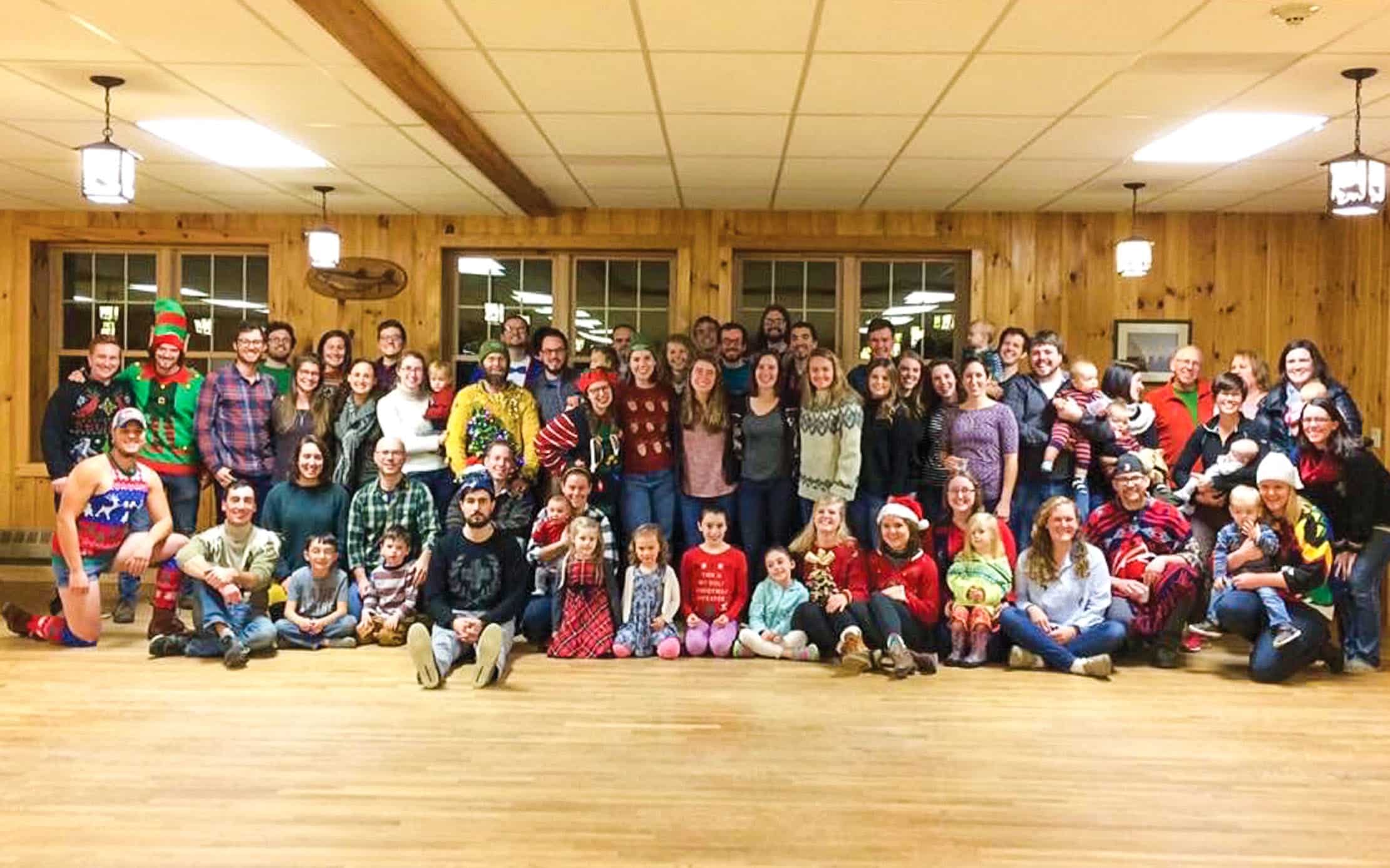 Alumni at a Christmas event smiling indoors