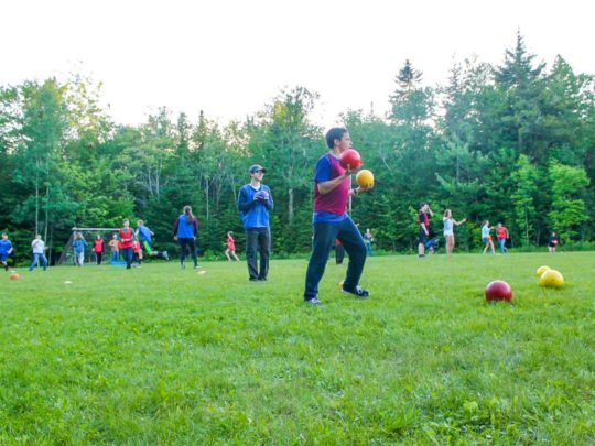 Campers playing soccer on the field