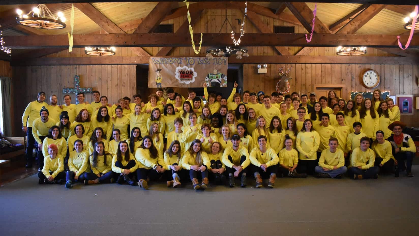 Alumni at the winter reunion wearing matching yellow shirts